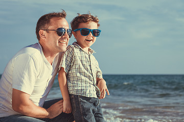 Image showing Father and son playing on the beach at the day time.