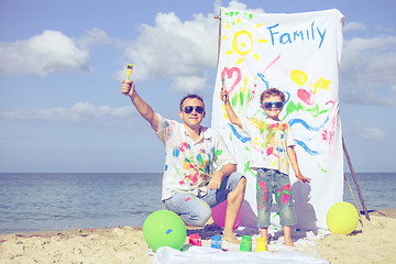 Image showing Father and son playing on the beach at the day time.