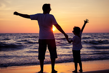 Image showing Father and son playing in the park at the sunset time. People ha