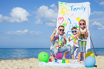 Image showing Father and children playing on the beach at the day time.