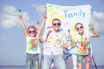 Image showing Father and children playing on the beach at the day time.