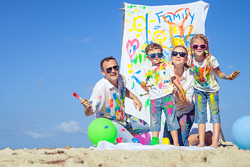 Image showing Happy family playing on the beach at the day time.