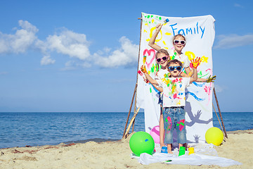 Image showing Two sisters and brother playing on the beach at the day time.