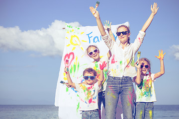 Image showing Mother and children playing on the beach at the day time.