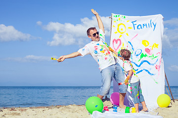 Image showing Father and son playing on the beach at the day time.