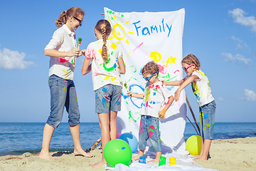 Image showing Mother and children playing on the beach at the day time.