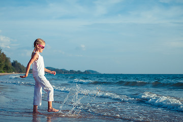 Image showing Little girl  dancing on the beach at the day time.