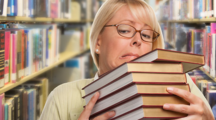 Image showing Beautiful Expressive Student or Teacher with Books in Library.