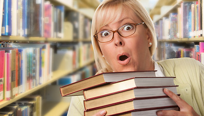 Image showing Beautiful Expressive Student or Teacher with Books in Library.