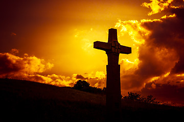 Image showing a stone cross in front of a dramatic evening sky