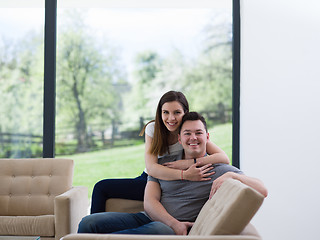 Image showing young handsome couple hugging on the sofa