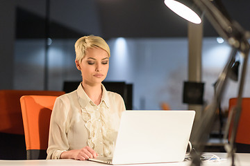 Image showing woman working on laptop in night startup office