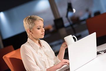 Image showing woman working on laptop in night startup office