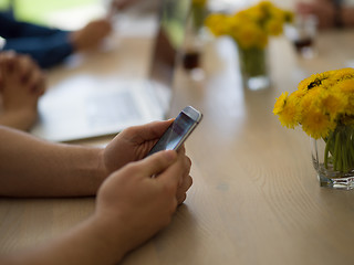 Image showing Young man holding smartphone