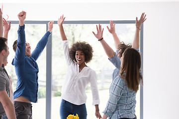 Image showing multiethnic startup Group of young business people celebrating s