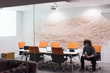 Image showing businessman relaxing at the desk