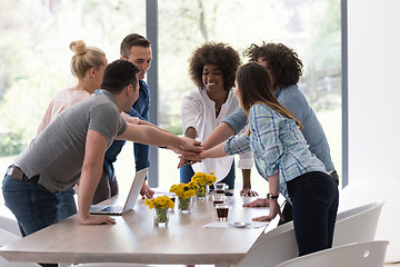 Image showing multiethnic startup Group of young business people celebrating s