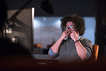 Image showing man working on computer in dark startup office