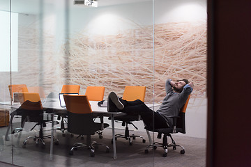 Image showing businessman relaxing at the desk