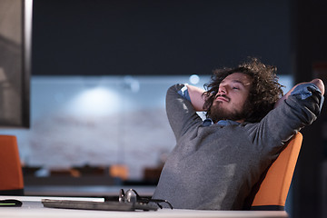 Image showing businessman relaxing at the desk