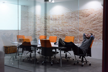 Image showing businessman relaxing at the desk