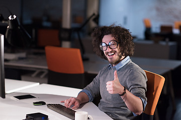 Image showing man working on computer in dark startup office