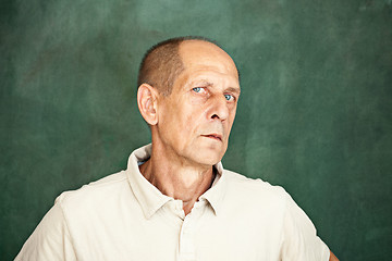 Image showing Worried mature man sitting at studio