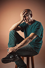 Image showing Worried mature man touching his head.