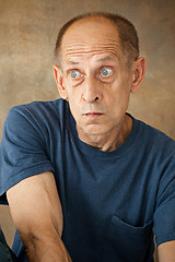 Image showing Worried mature man sitting at studio