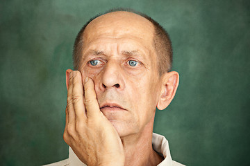 Image showing Worried mature man touching his head.