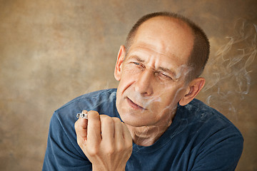 Image showing Worried mature man sitting at studio