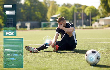 Image showing injured soccer player with ball on football field