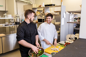 Image showing chef and cook cooking food at restaurant kitchen