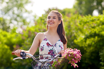 Image showing happy woman riding fixie bicycle in summer park