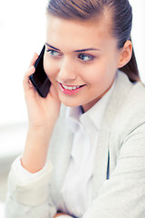 Image showing businesswoman with smartphone in office