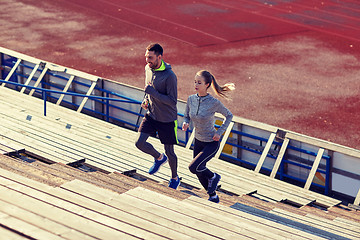 Image showing couple running upstairs on stadium