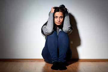 Image showing unhappy woman crying on floor at home