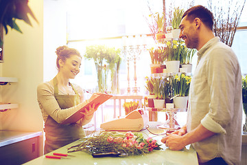 Image showing florist woman and man making order at flower shop