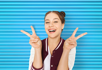 Image showing happy smiling teenage girl showing peace sign