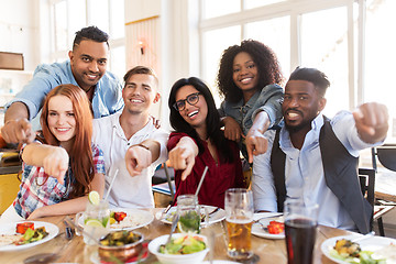 Image showing happy friends eating at restaurant