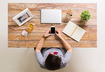 Image showing woman with smartphone and laptop at office table