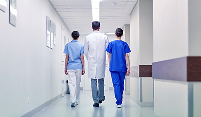 Image showing group of medics or doctors walking along hospital