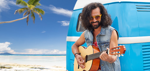 Image showing hippie man playing guitar at minivan car on beach