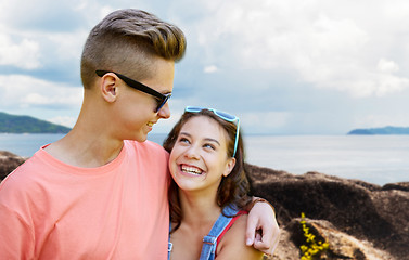 Image showing happy teenage couple hugging outdoors