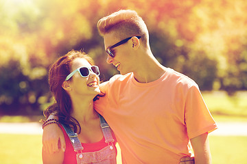 Image showing happy teenage couple looking at each other in park