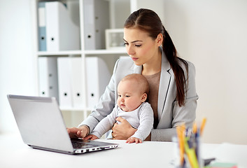 Image showing happy businesswoman with baby and laptop at office