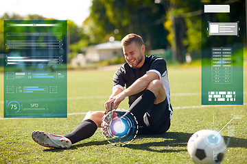 Image showing injured soccer player with ball on football field