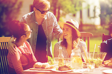 Image showing happy friends having dinner at summer garden party