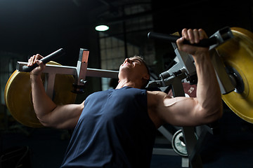 Image showing man doing chest press on exercise machine in gym