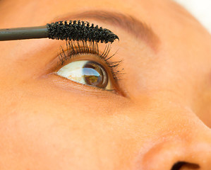 Image showing Girl Applying Mascara On Her Eyelashes Shows Cosmetics